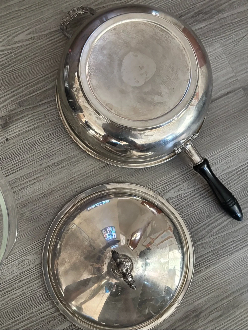 Pyrex glass insert inside a covered silver-plated pot with lid. Used